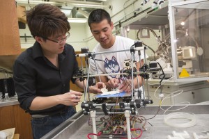 Chemical engineering student Derek Chhiv '14, right, discusses with Professor Anson Ma his group’s prototype for an artificial kidney.