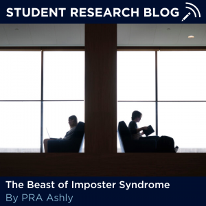 Text that reads: "Student Research Blog" on top with "The Beast of Imposter Syndrome by PRA Ashly" at the bottom. In the middle of the two texts is an image of two students sitting in silhouette back to back on either side of a wall. A window behind them illuminates them. 