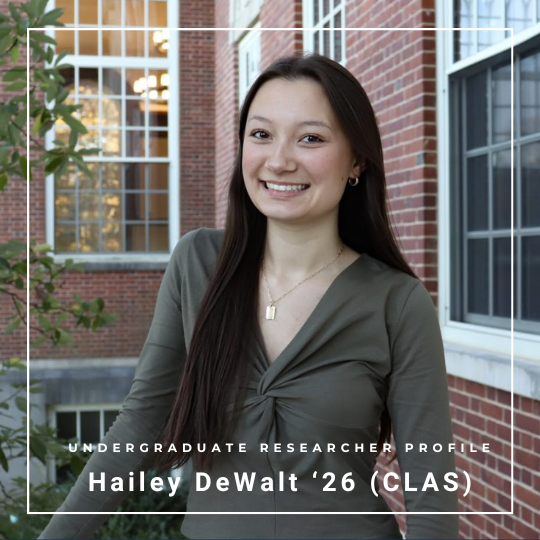 Student looking at the camera and smiling with background of brick building - text: Undergraduate Researcher Profile - Hailey DeWalt '26 (CLAS) and link: https://today.uconn.edu/2026/04/meet-the-graduate-hailey-dewalt-clas/.